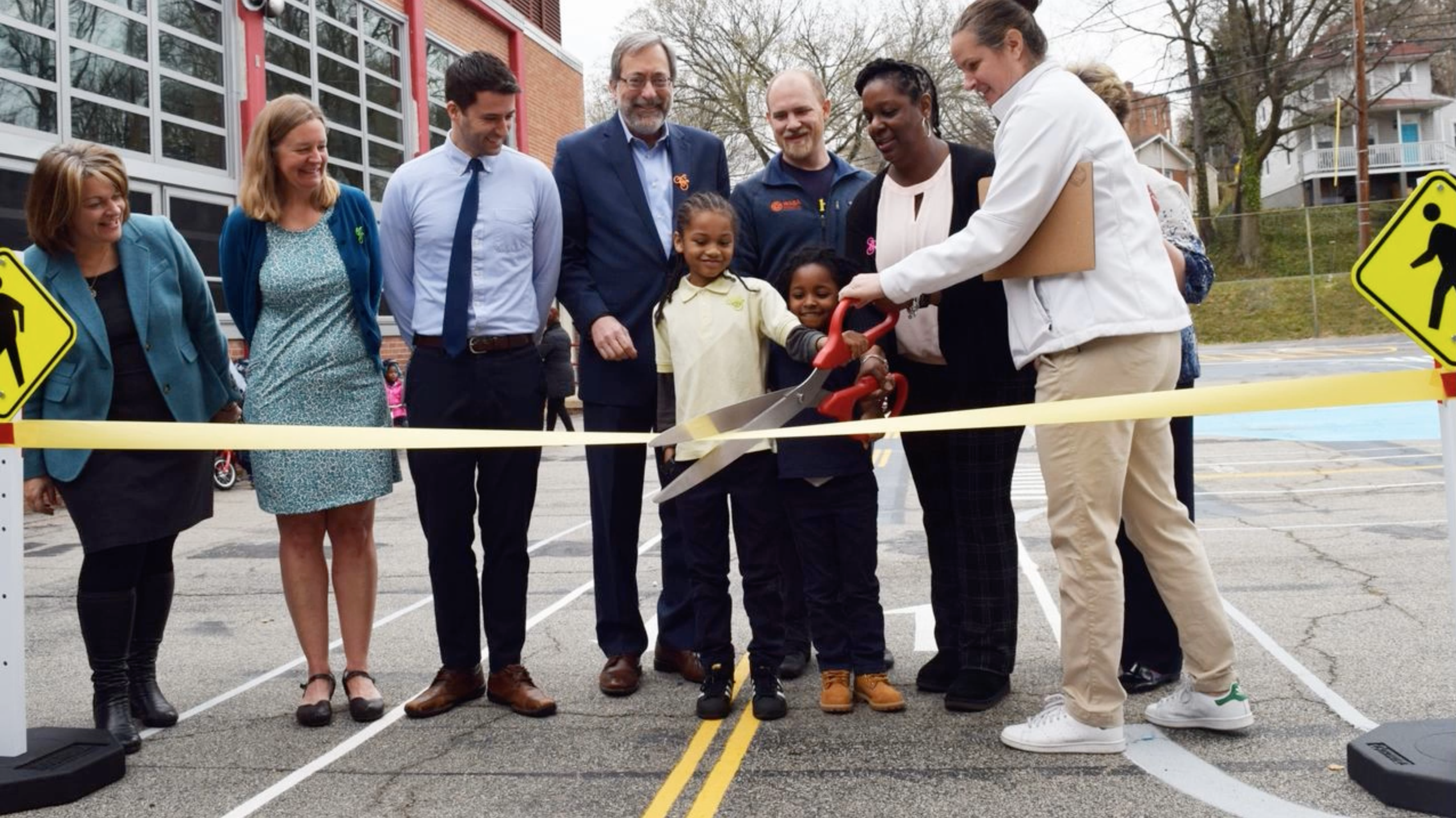 children cutting a ribbon on a new project