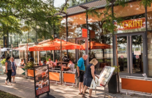 Two people pause to read a menu outside of a Capitol Riverfront restaurant